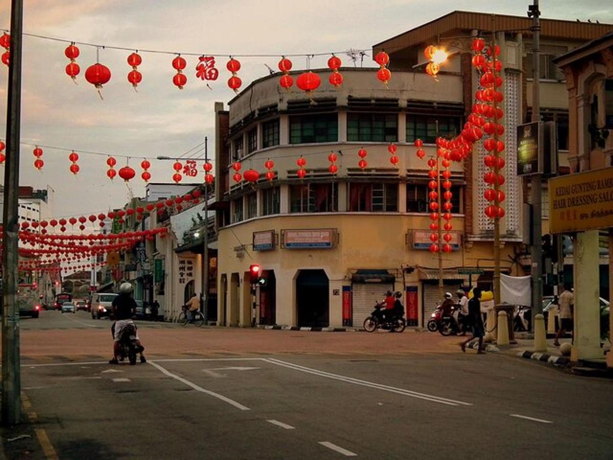 a city street with red lanterns and a building