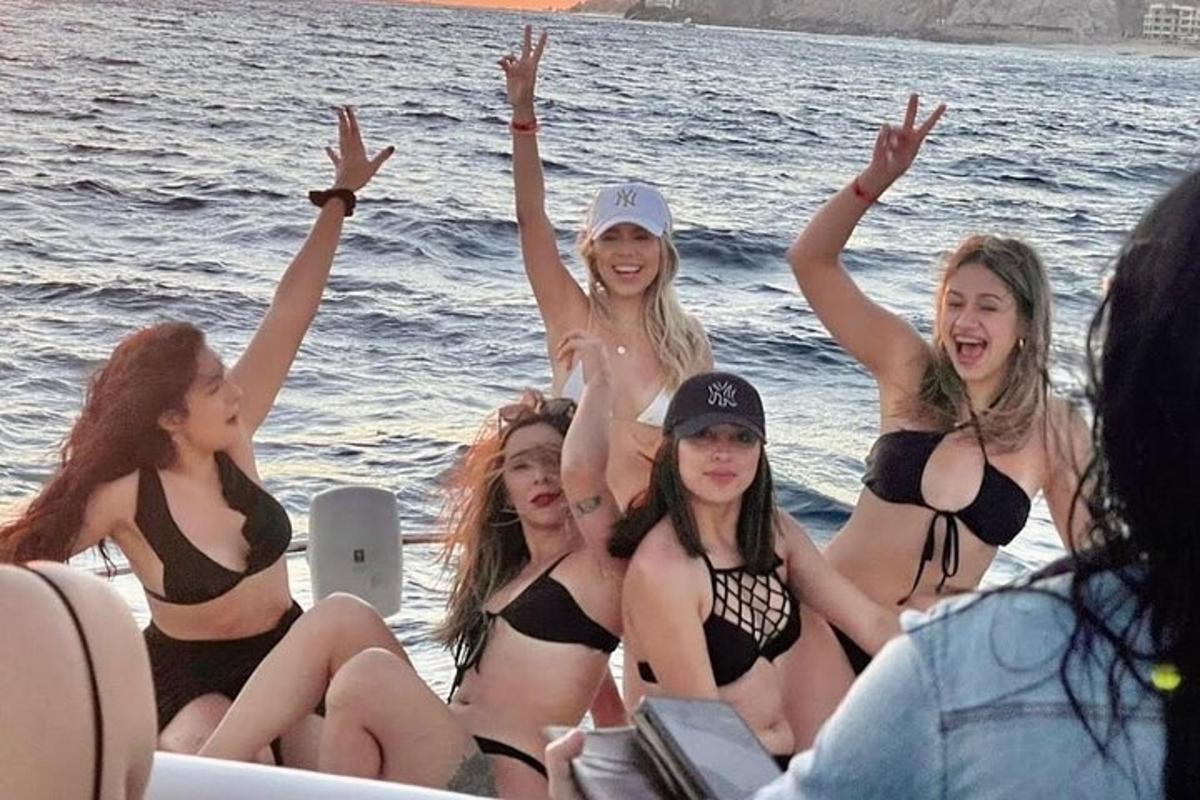 a group of women in bathing suits on a boat