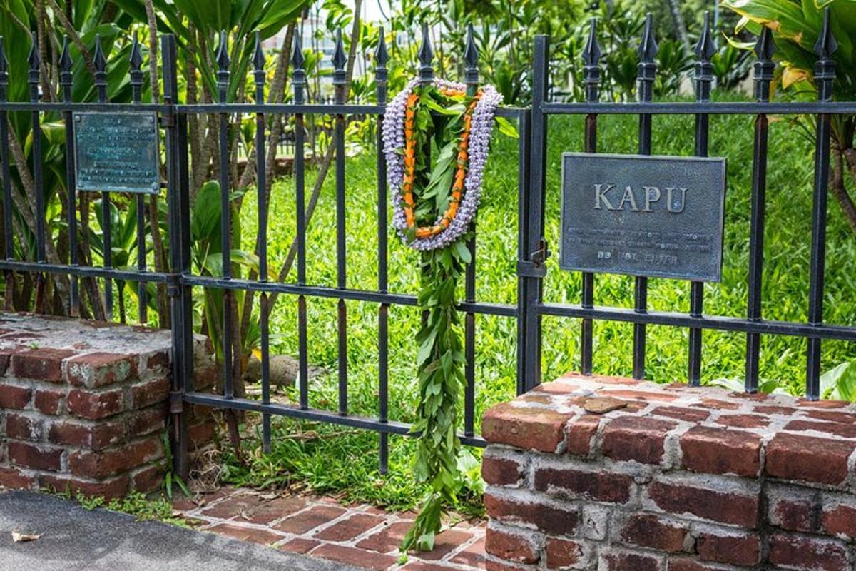 a black fence with a sign that says kapu on it