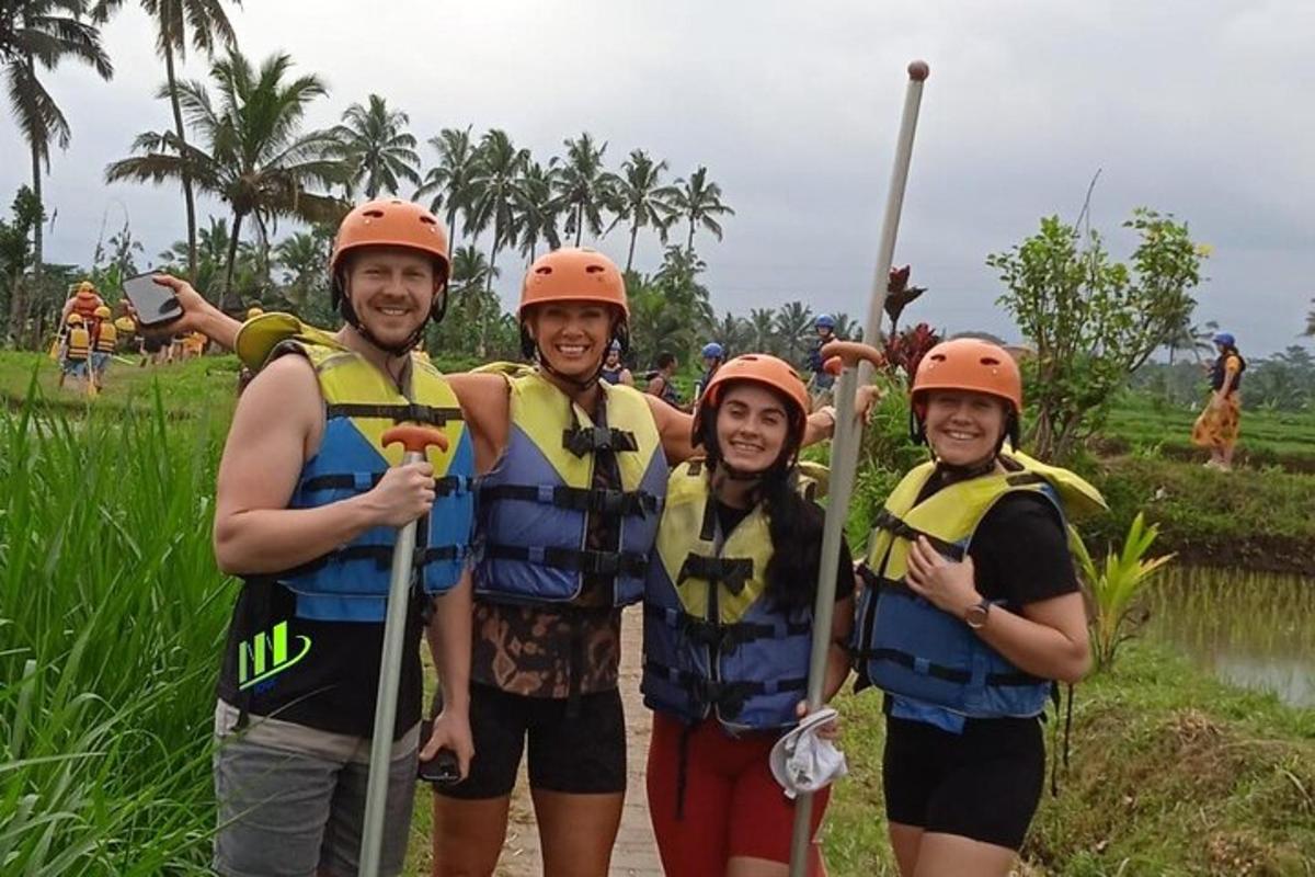 a group of three people wearing life jackets and holding paddles