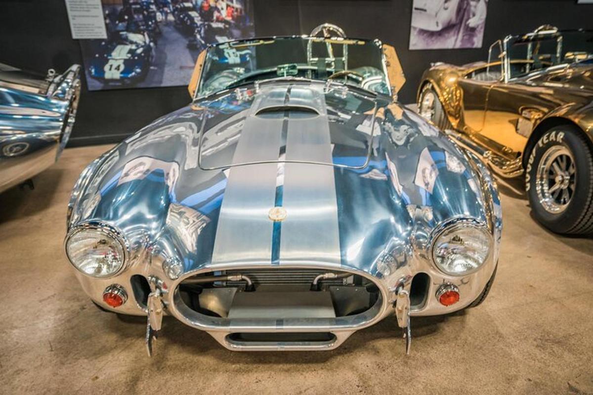 a silver car on display in a museum