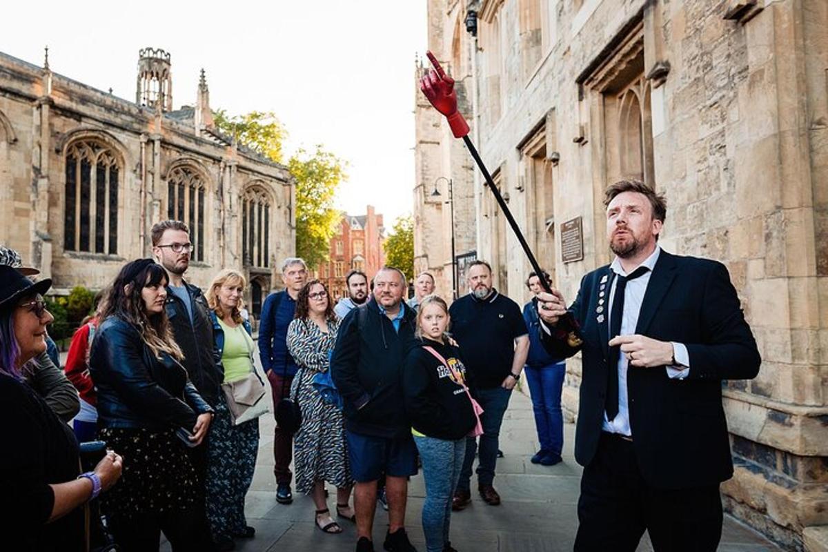 a man in a suit holding a stick in a group of people