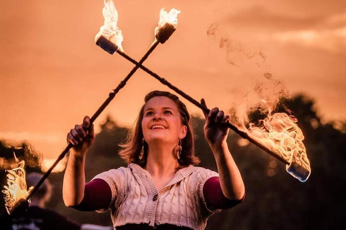 una giovane ragazza che tiene in mano due bastoni con il fumo