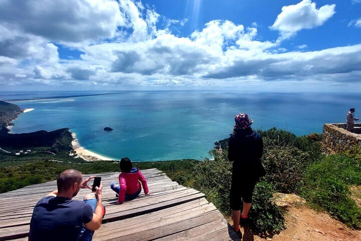 a group of people taking pictures of the ocean