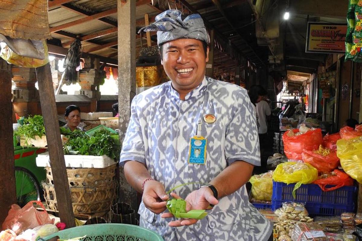 a man in a market holding a bunch of vegetables