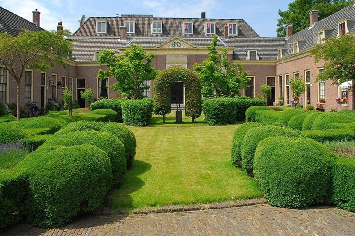 a large house with a large yard with bushes
