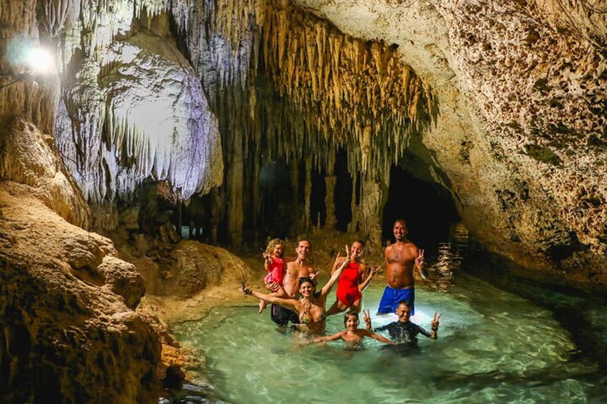 a group of people in the water in a cave