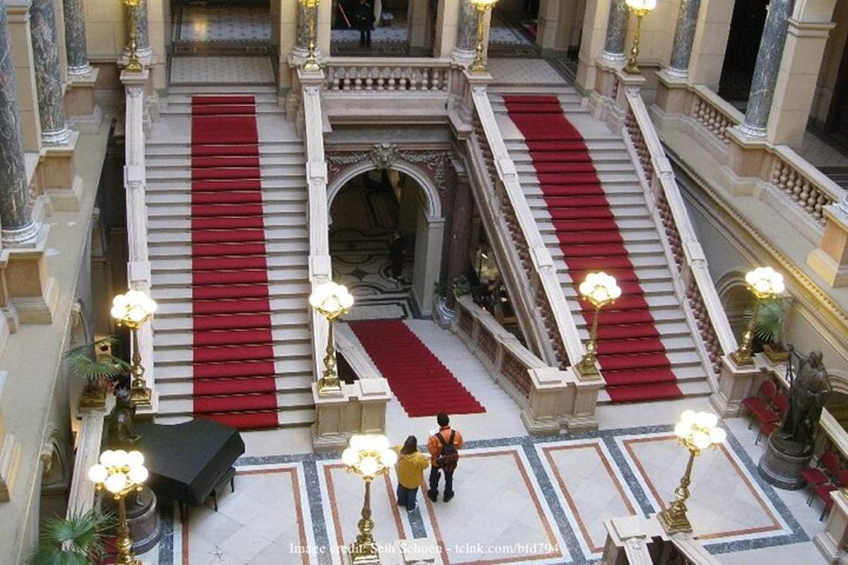 two people walking down the stairs in a building