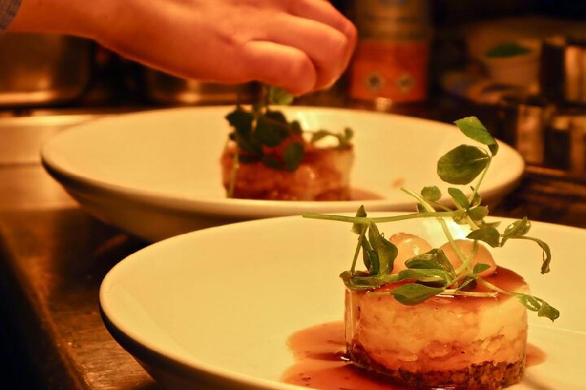 a person putting a piece of food on a plate