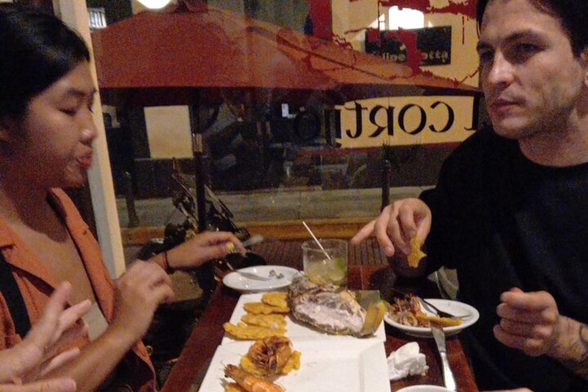 a group of people sitting at a table eating food