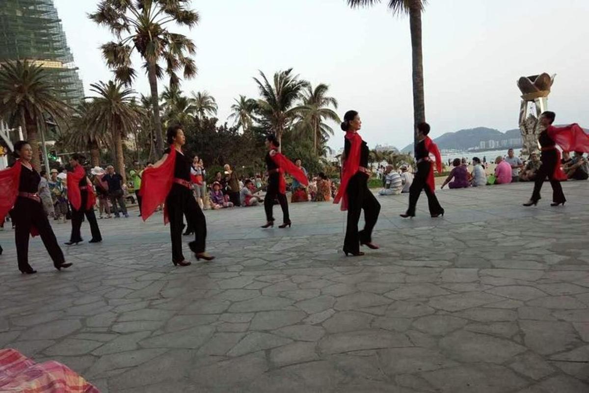 a group of people are dancing in a street