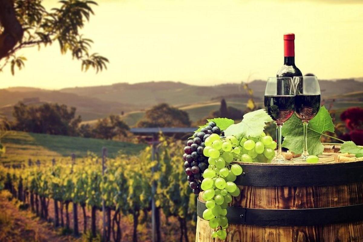 una bottiglia di vino e un grappolo d'uva su una botte