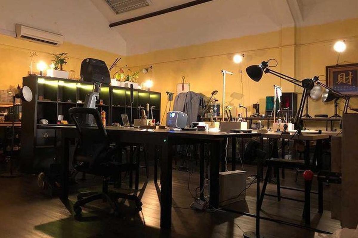 a room with a desk and chairs in a room