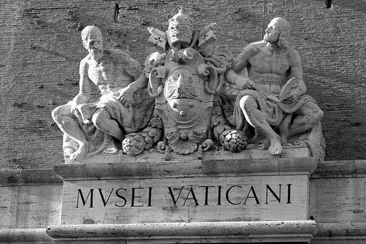 a statue of three men sitting on a horse on a building