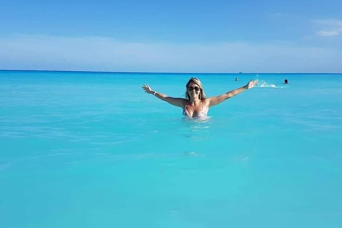 a woman in the ocean with her arms outstretched