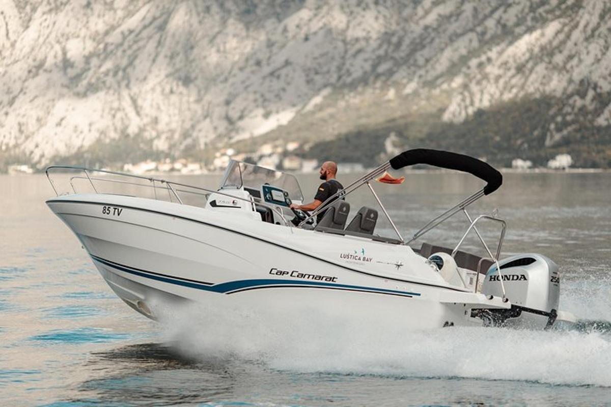 a man is driving a boat on the water