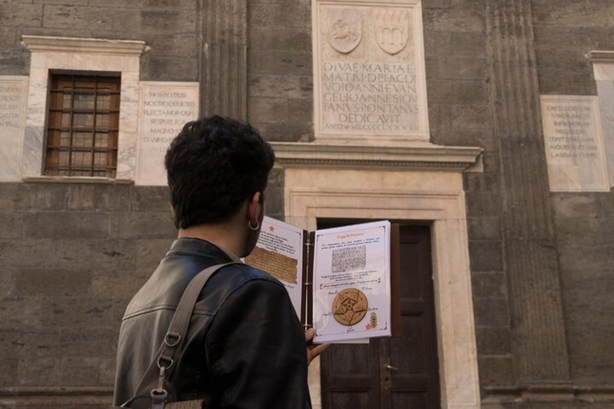 a man reading a book in front of a building