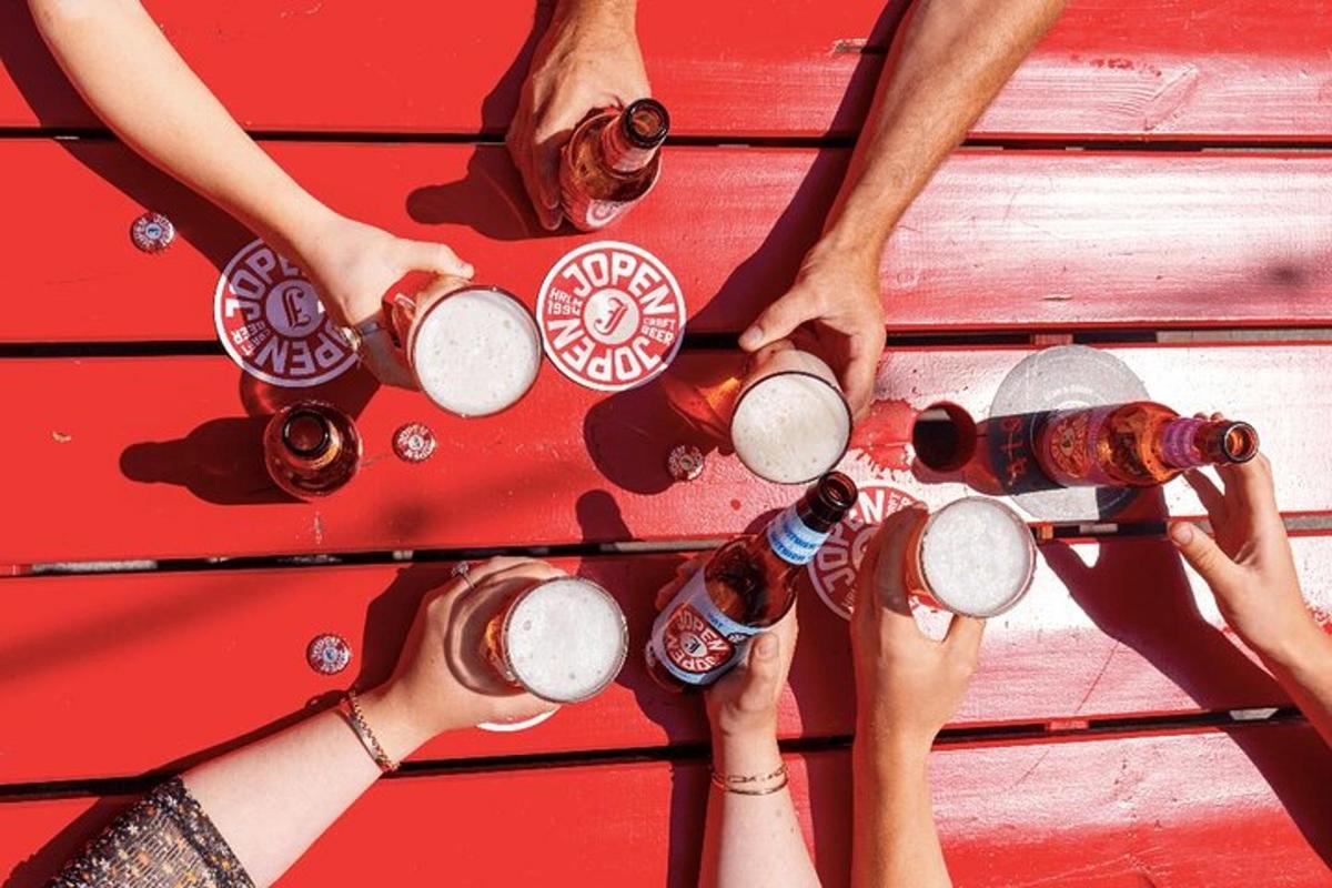 a group of people holding upints of beer