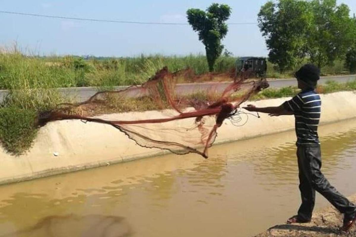 a man holding a net in the water