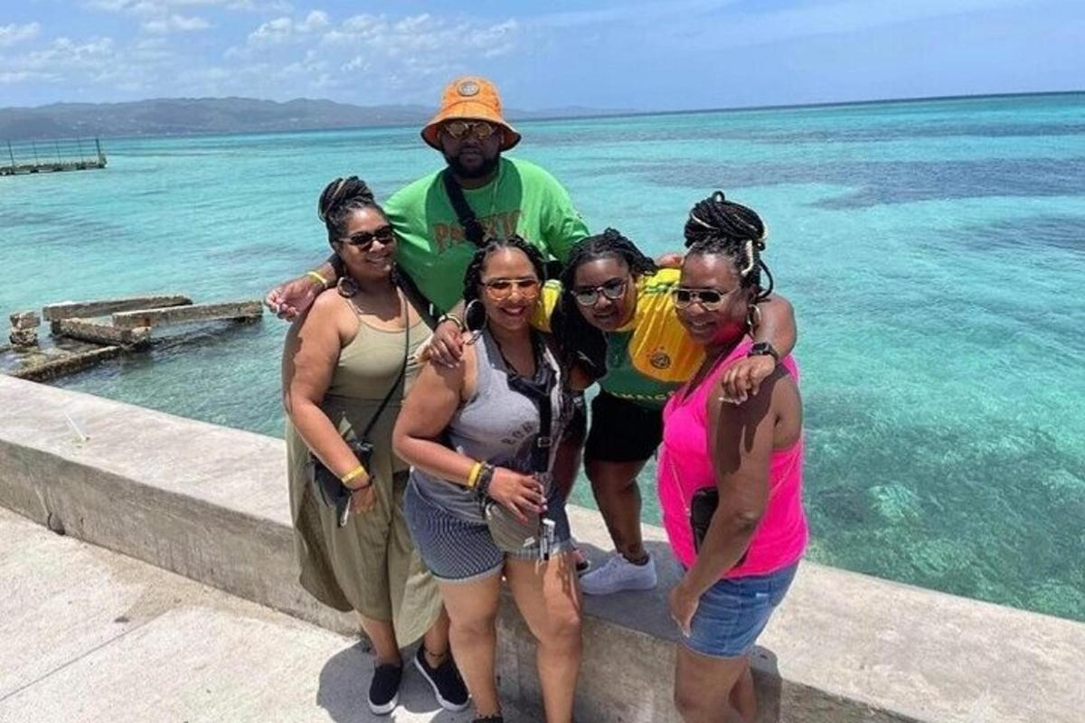 a group of women standing next to the ocean