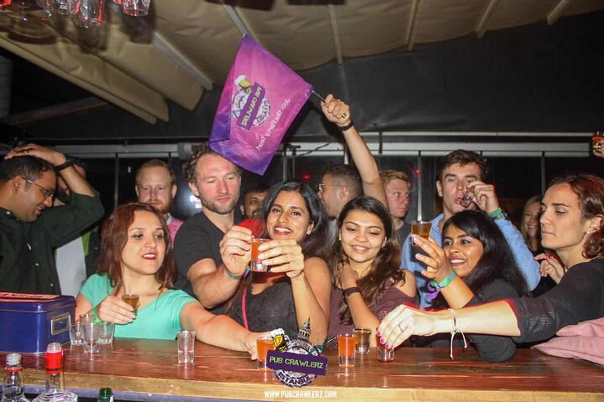a group of people standing around a table with drinks