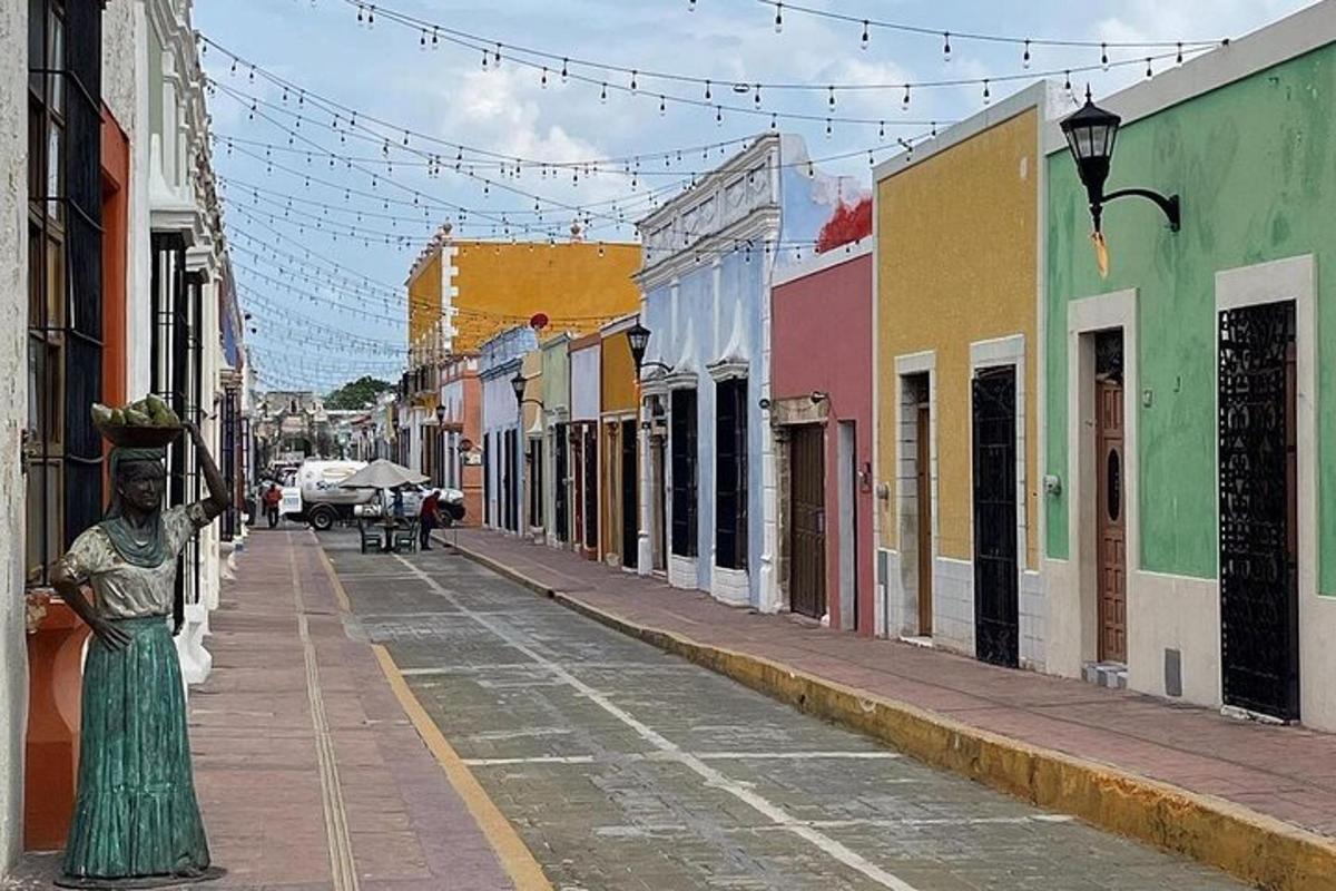 a street with a statue of a woman walking down a street