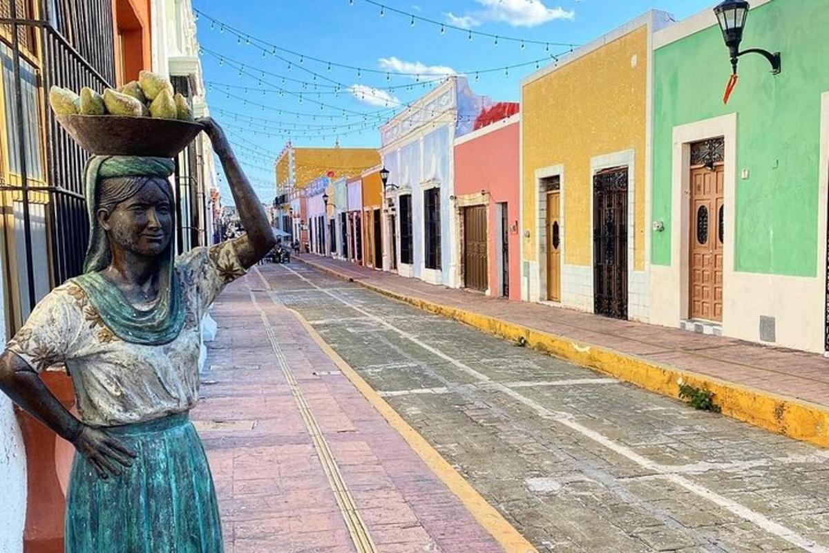 a statue of a woman holding a basket of bananas on a street