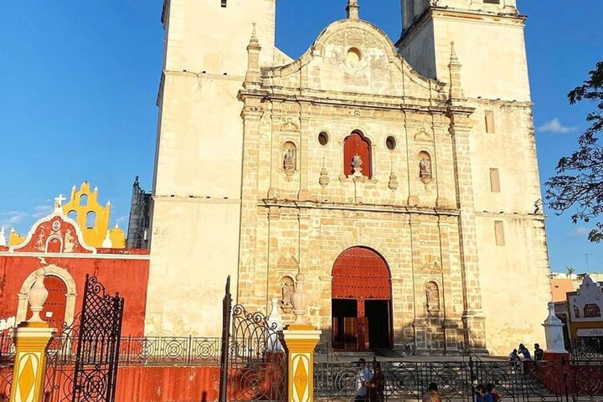 a building with a tower with a fence in front of it