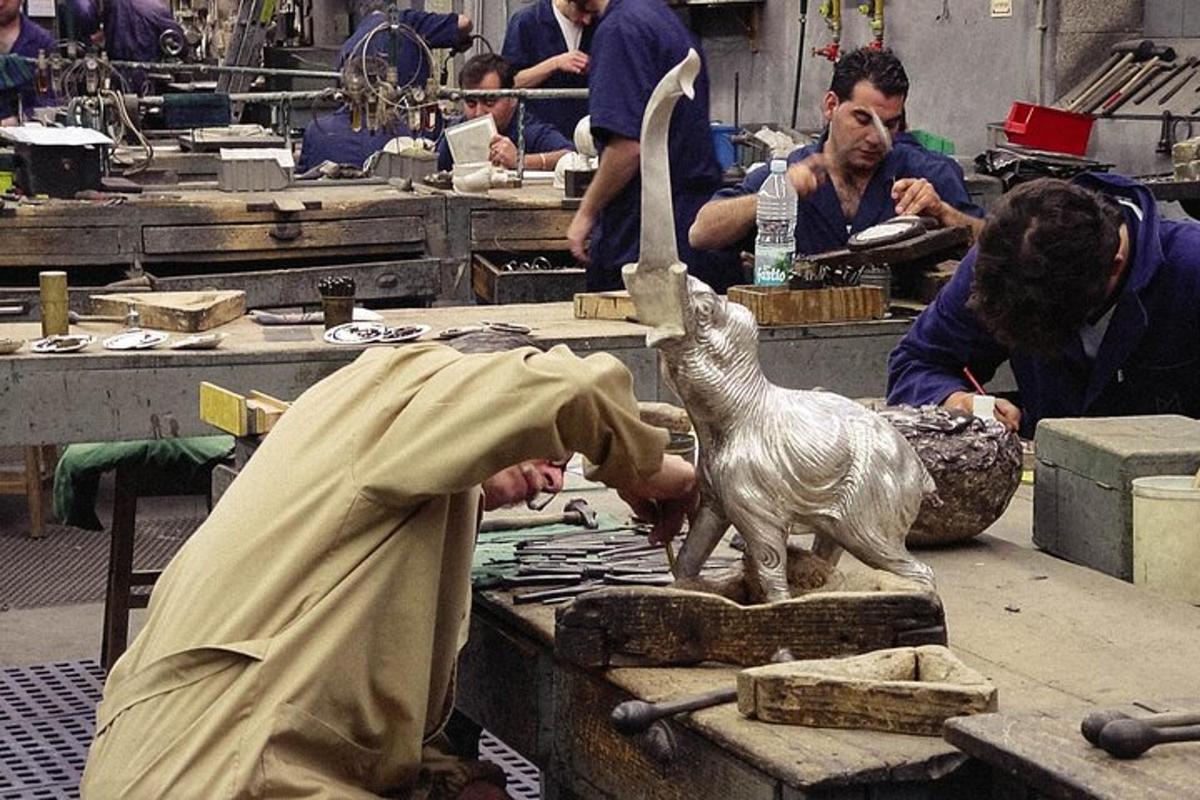a group of people working on a statue in a workshop