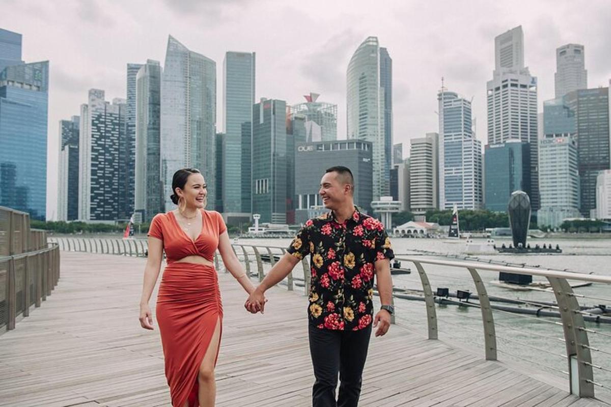 a man and woman holding hands while walking on a boardwalk