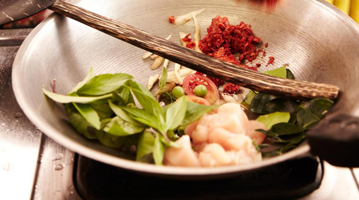 a bowl of food with chopsticks on top of it