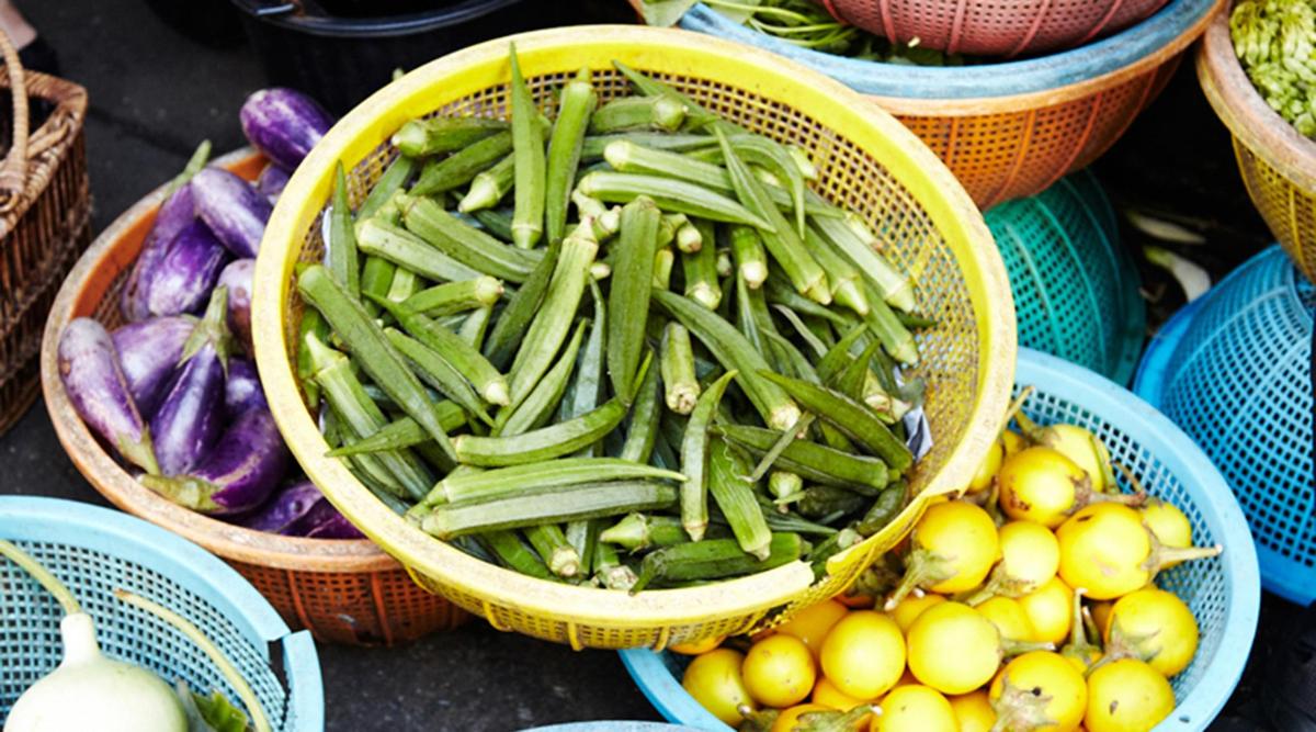 a basket filled with green beans and other vegetables