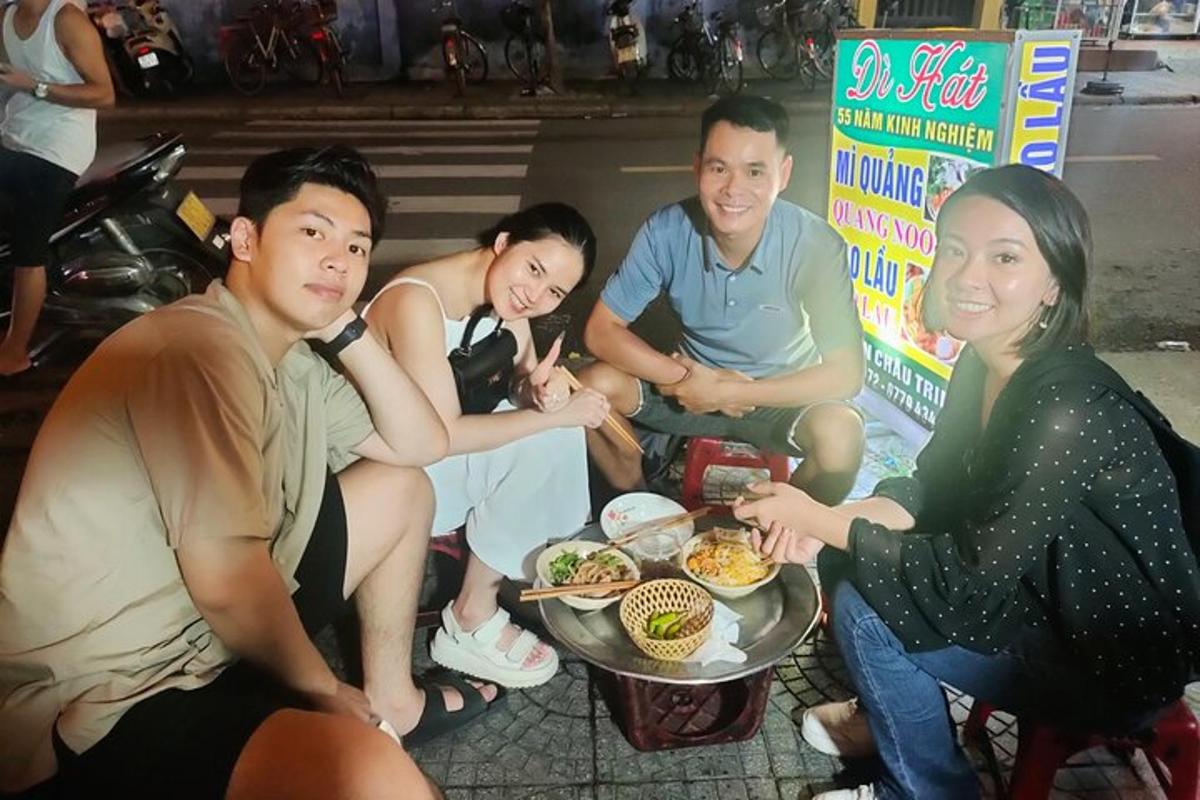 a group of people sitting around a table eating food