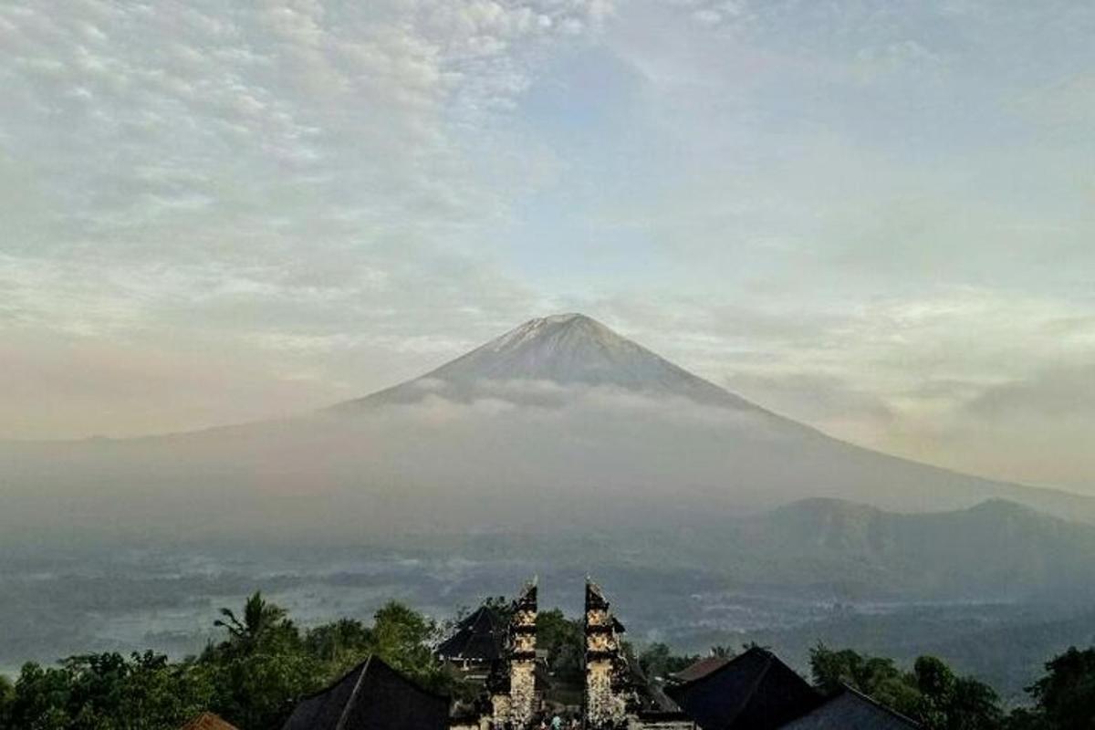 a mountain in the distance with buildings in the foreground
