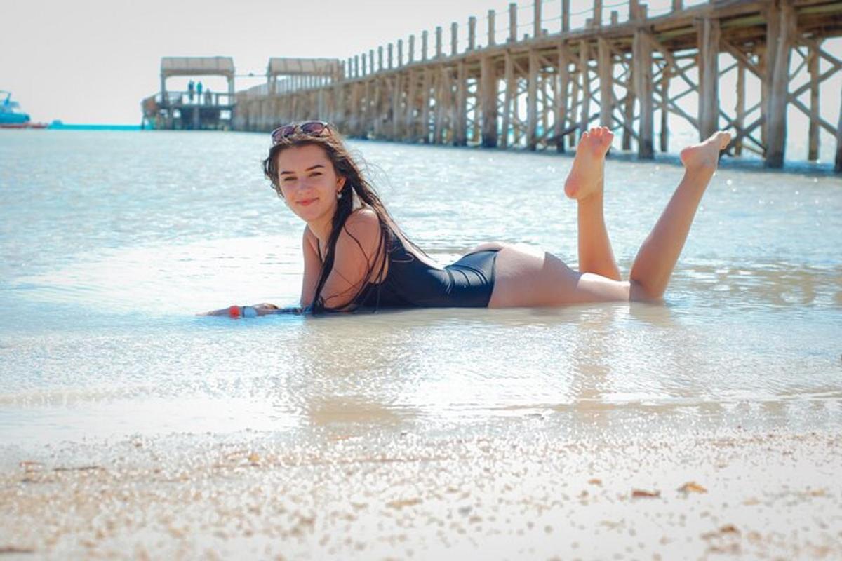 una mujer tumbada en el agua en la playa