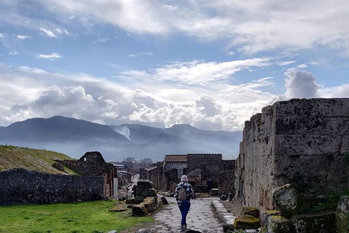 a man walking down a stone street