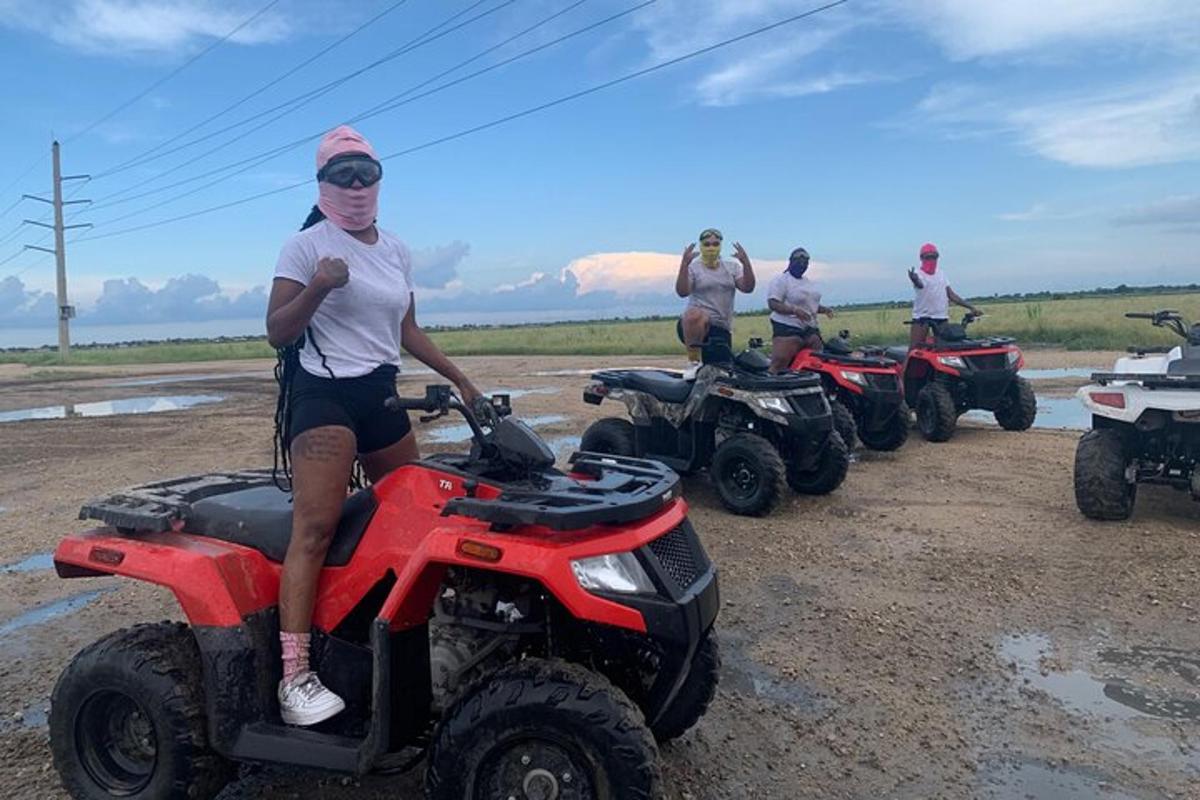 a group of men sitting on atvs on a dirt road