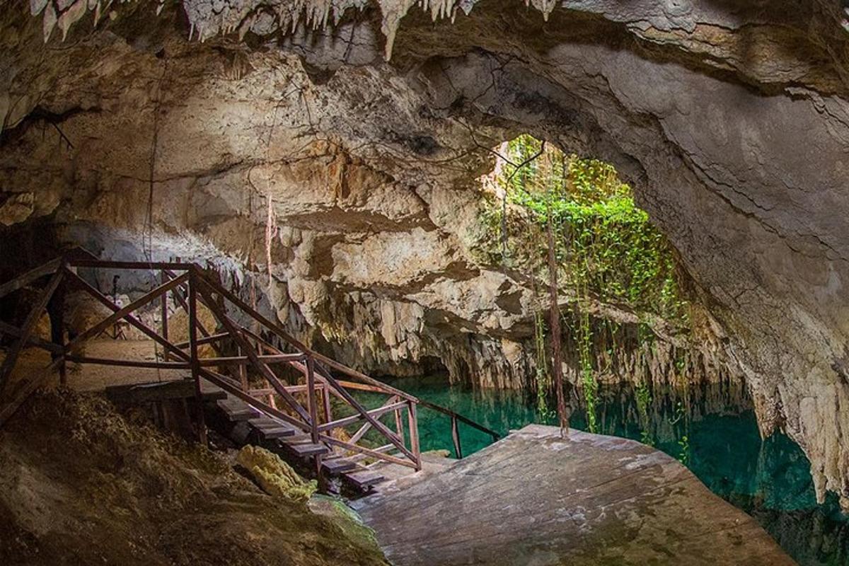 a staircase in a cave with a pool of water