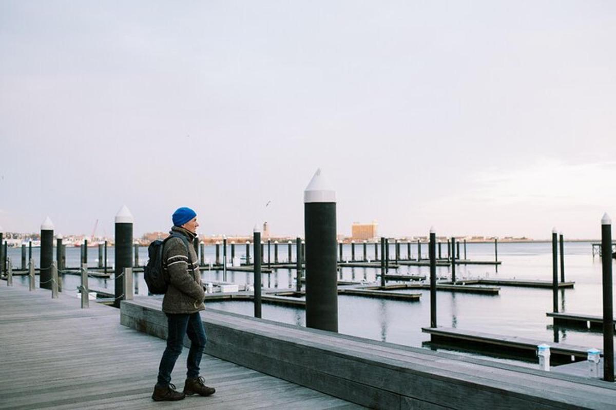 a man standing on a pier near the water