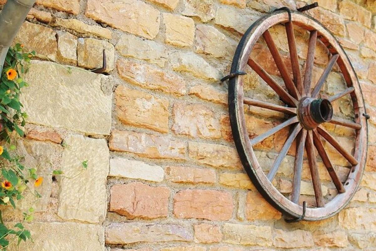 a wooden wheel attached to a brick wall