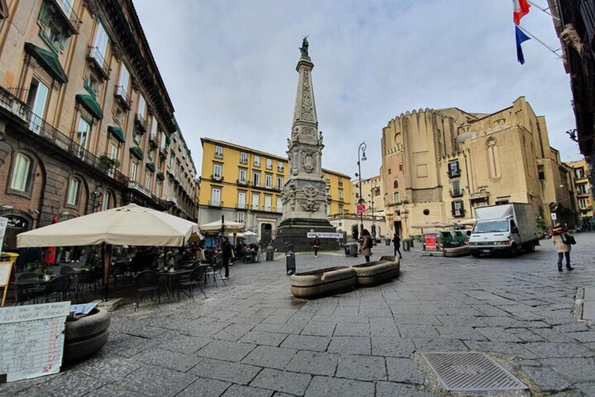 a clock tower in the middle of a city street