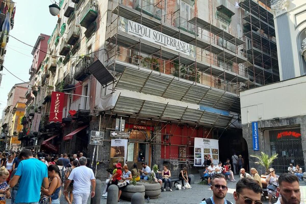 a crowd of people walking around a street in front of a building