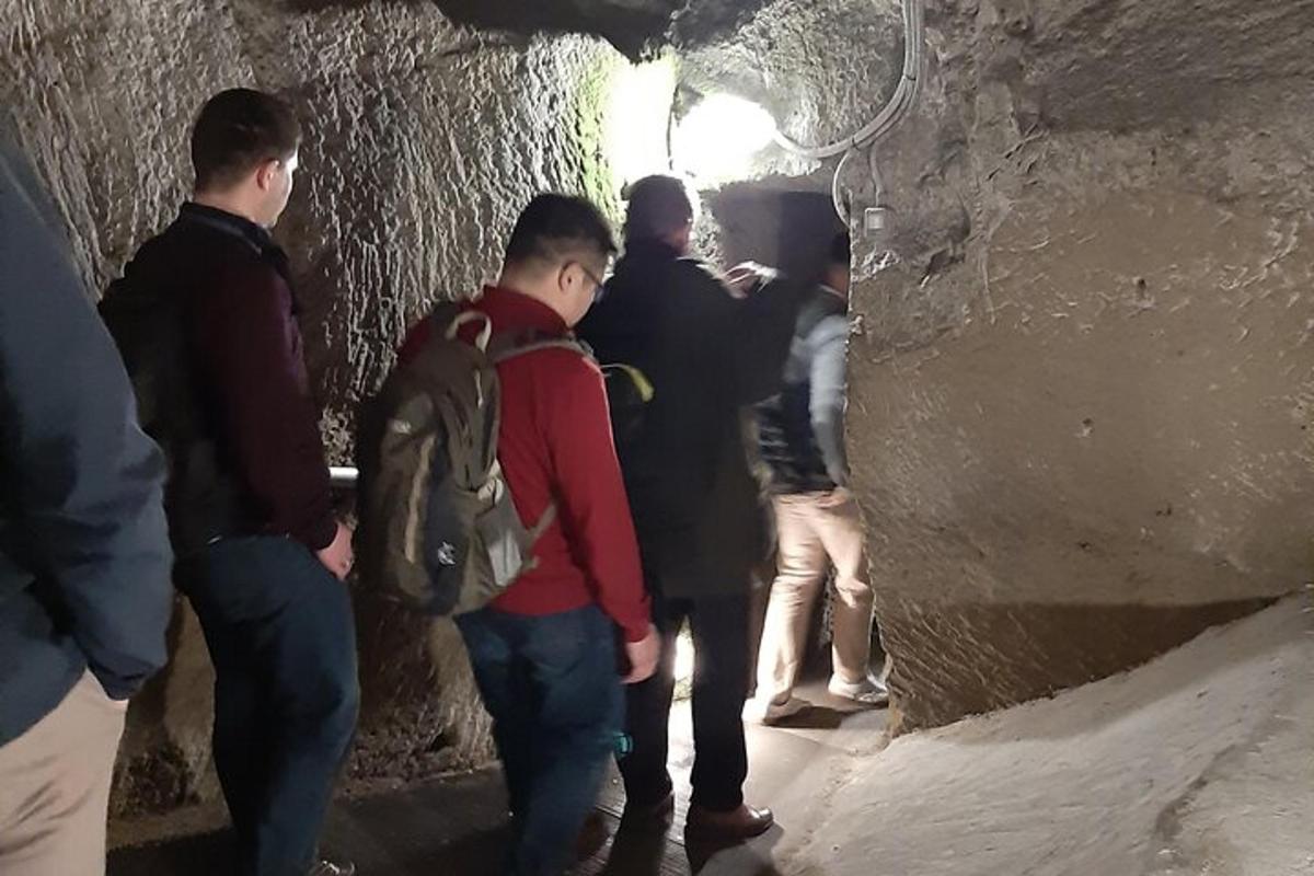 a group of people standing in a dark tunnel