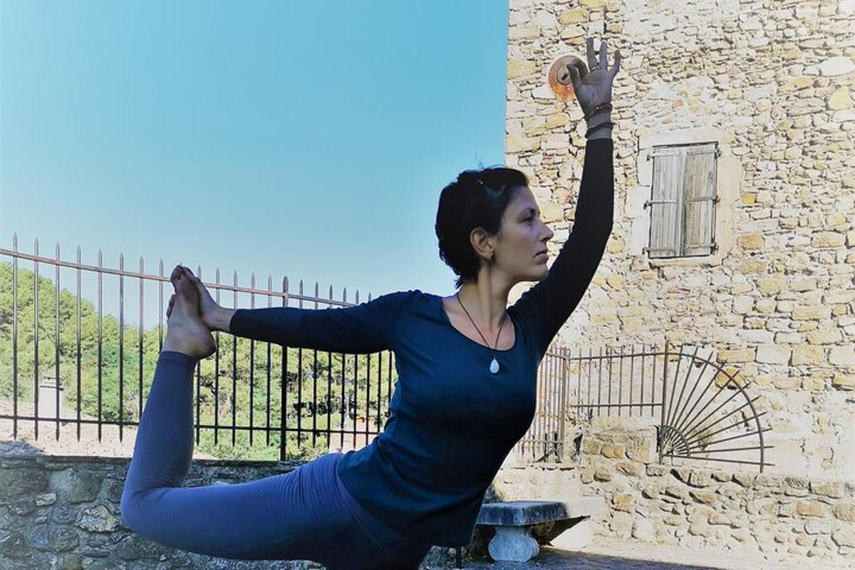 a woman doing yoga in front of a building
