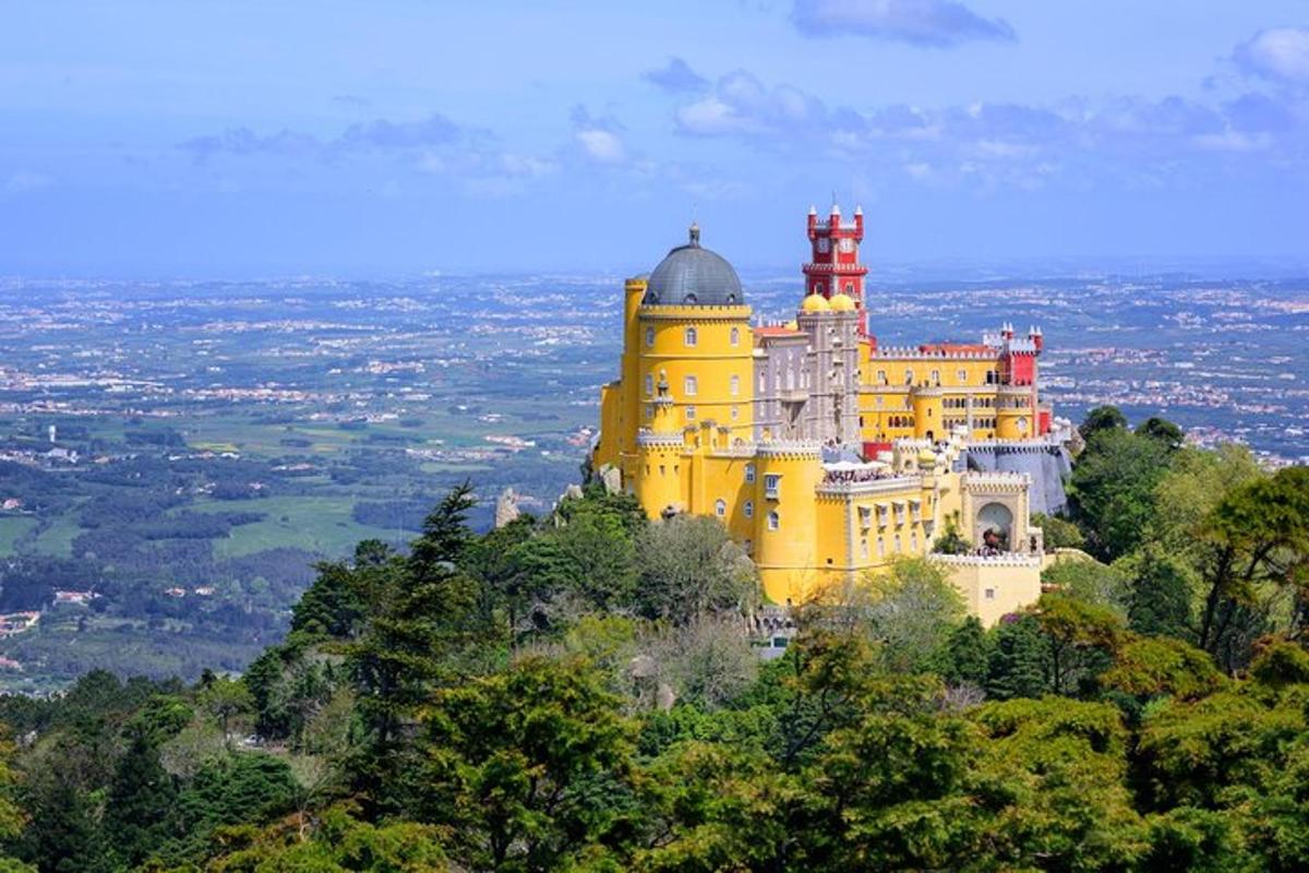 a large yellow building on top of a mountain