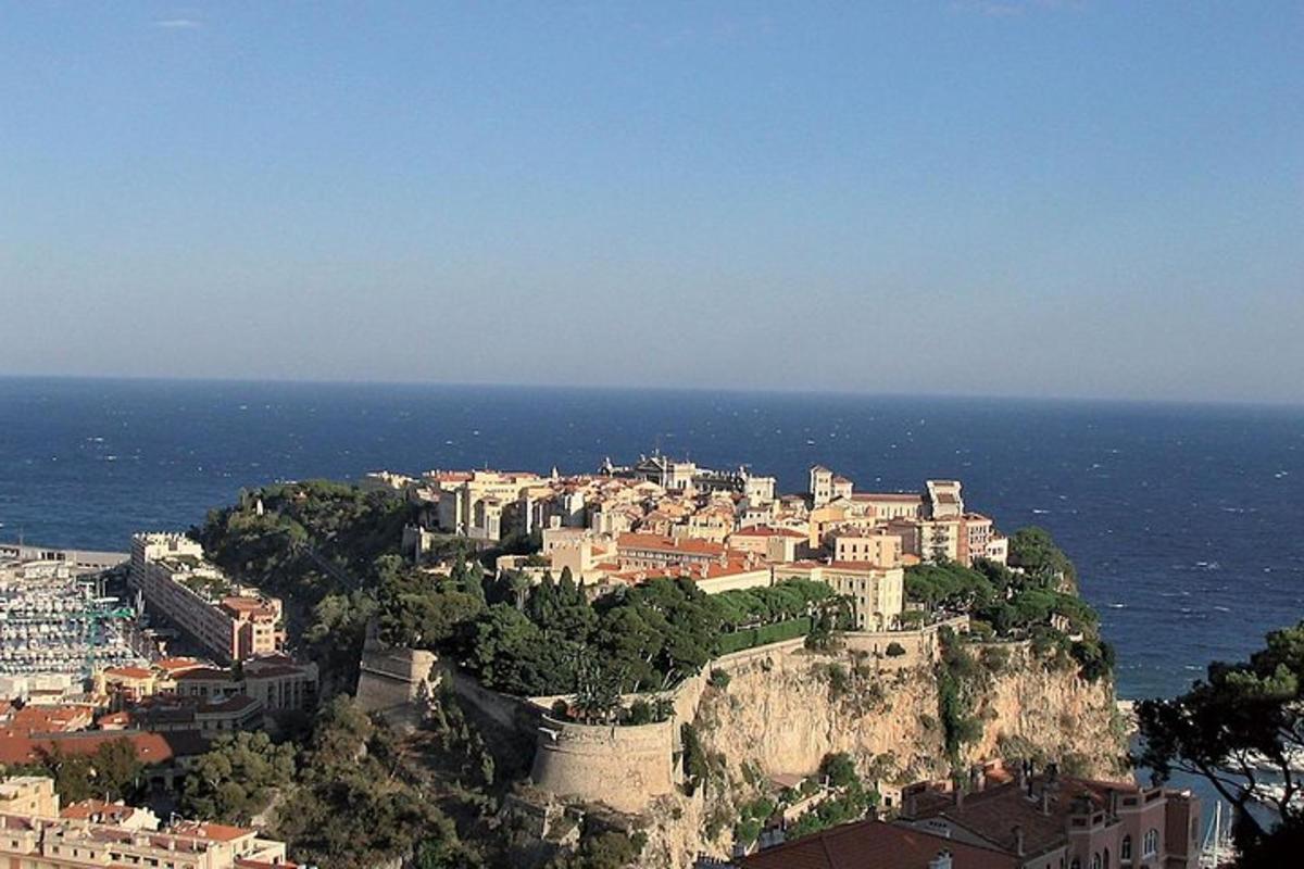 a town on top of a mountain near the ocean