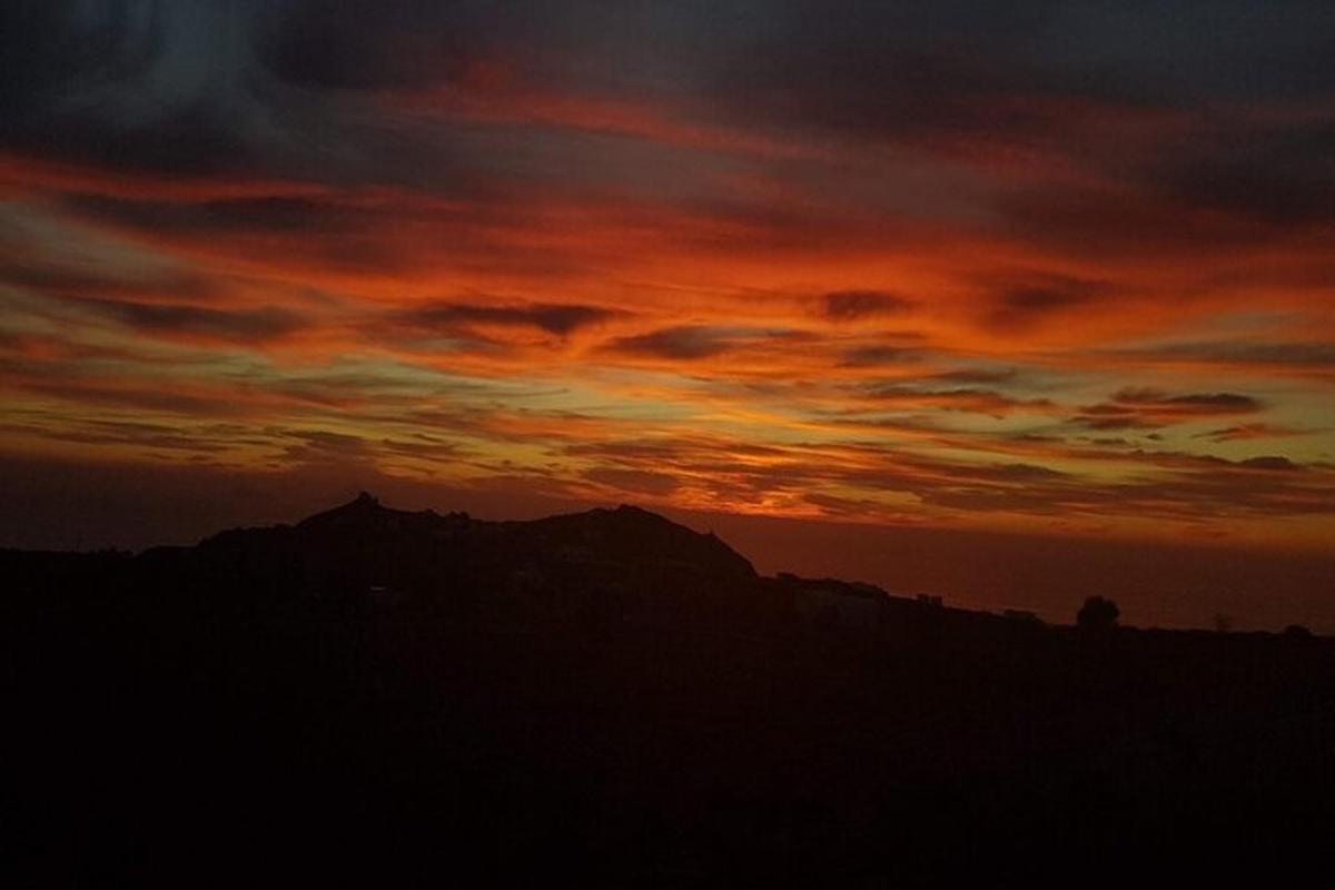 a sunset with the mountains in the background
