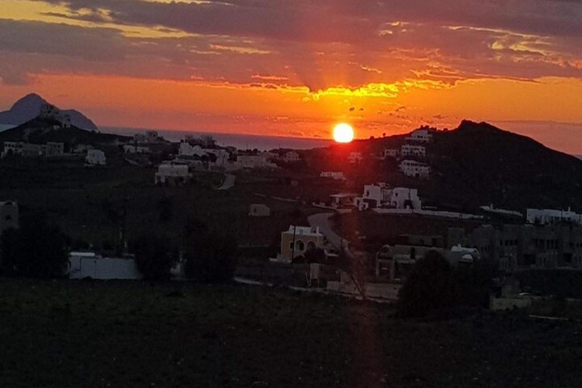 a sunset view of a city with the sun setting
