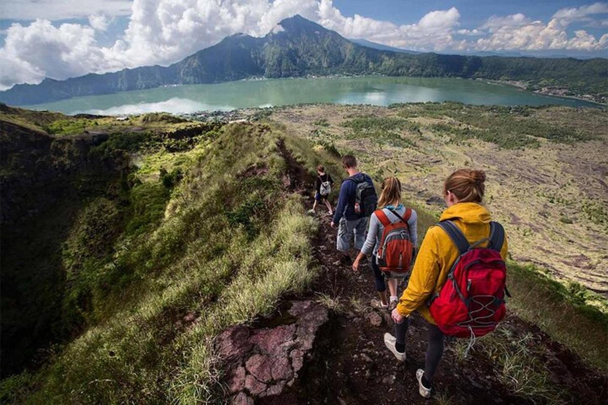 a group of people walking on a mountain trail