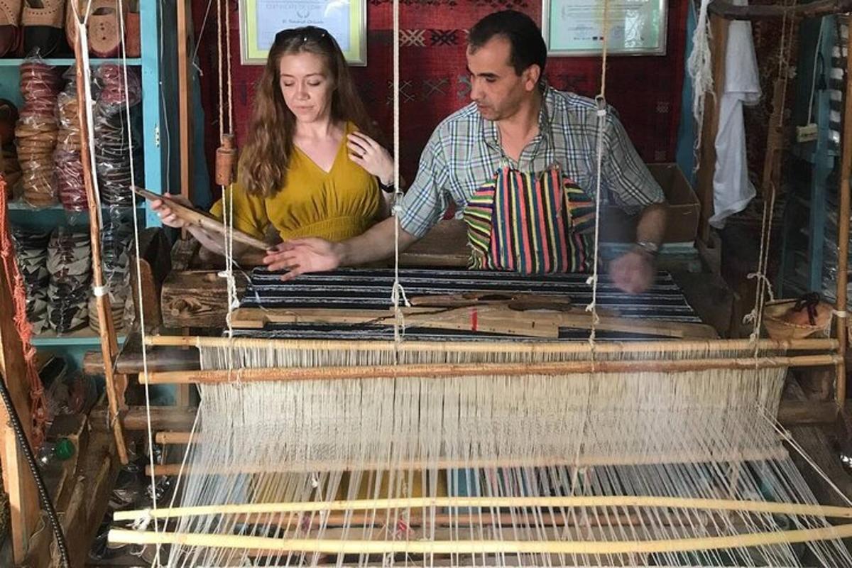 a man and a woman working on a weaving machine